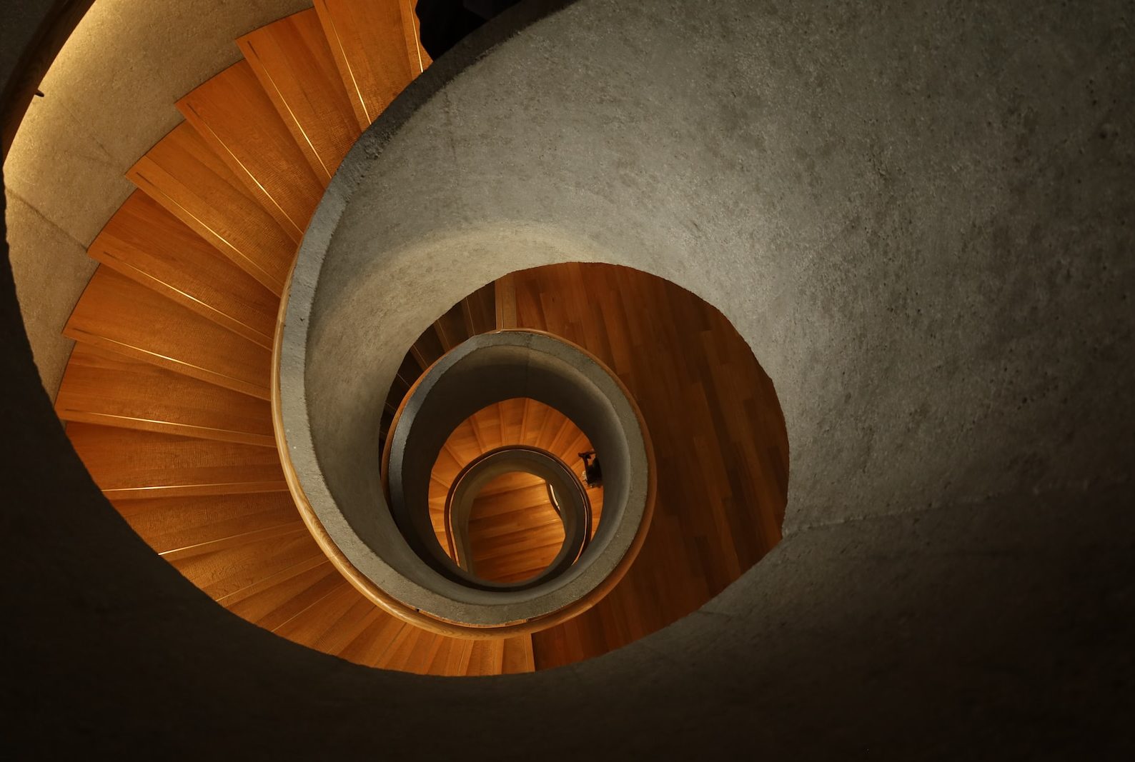 a spiral staircase with a person walking up it